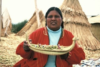 woman sharing food in Puno, Peru