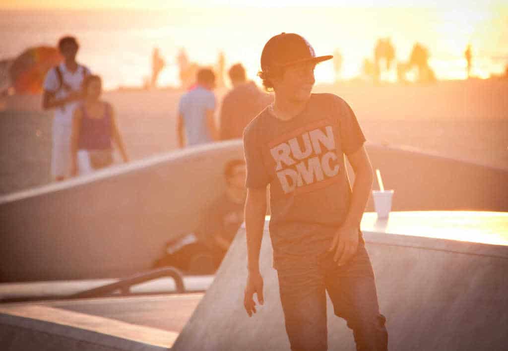 Young boy skating in los angeles sunset california