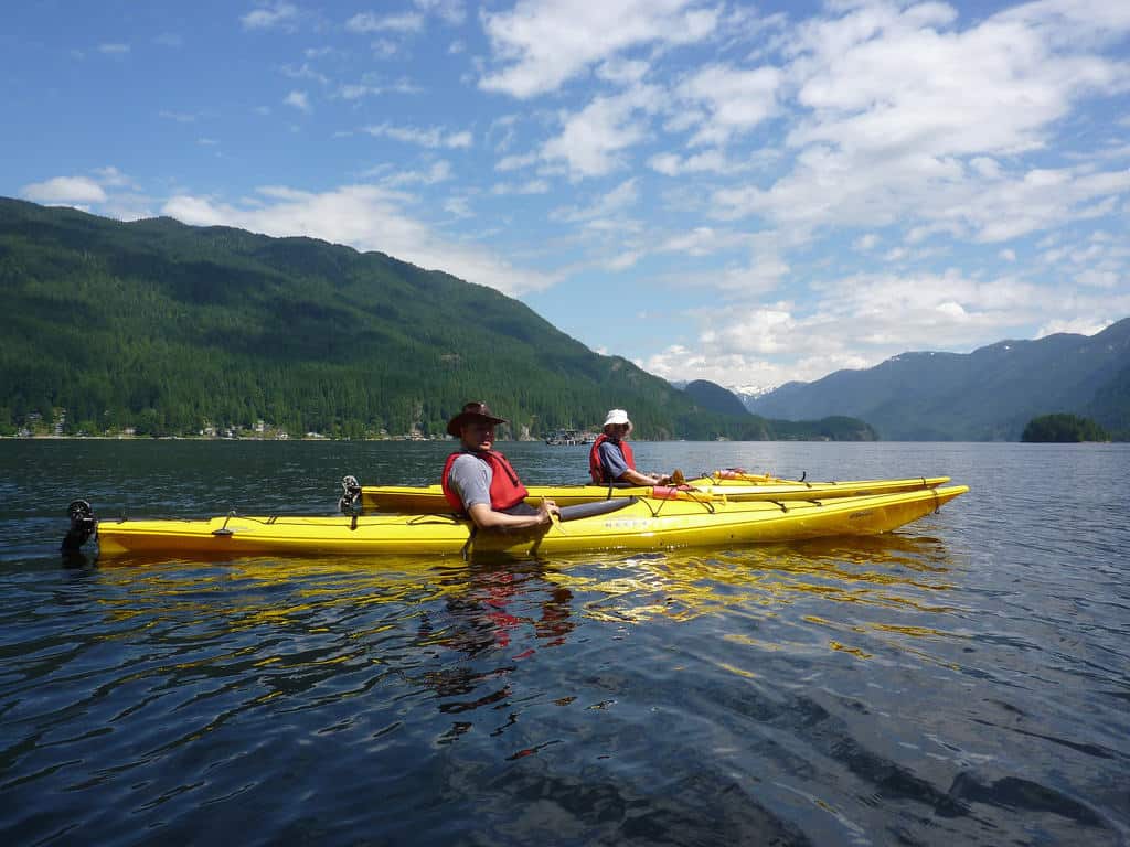 family kayaking on pretty lake