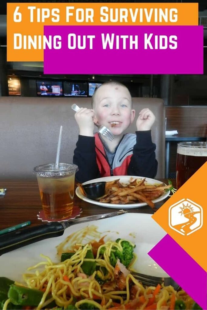 little boy eating in restaurant