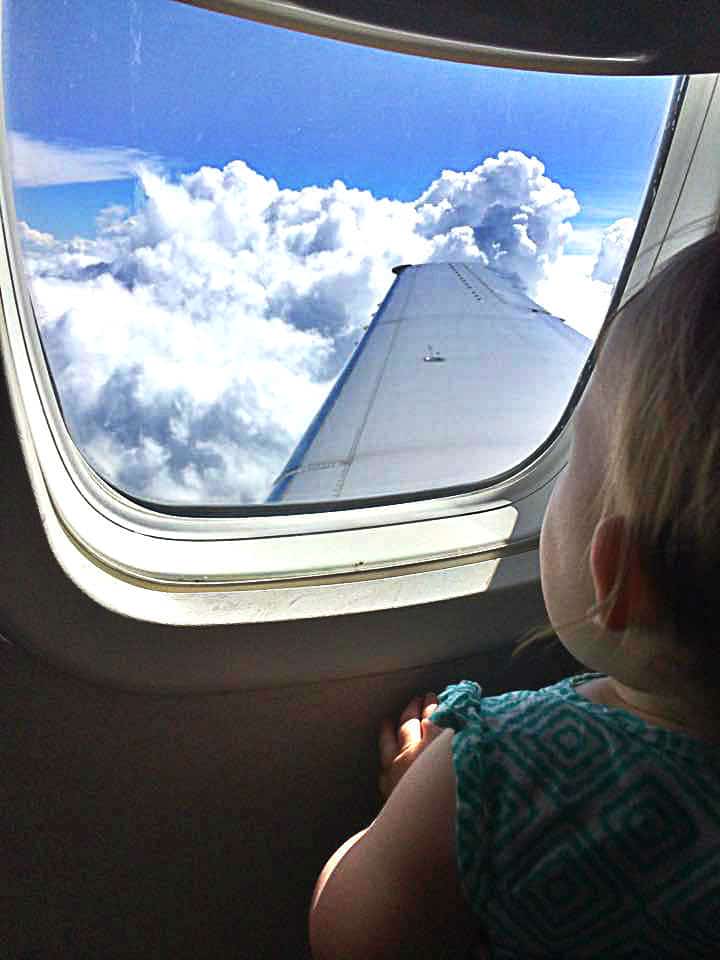 baby looking out window on a United flight