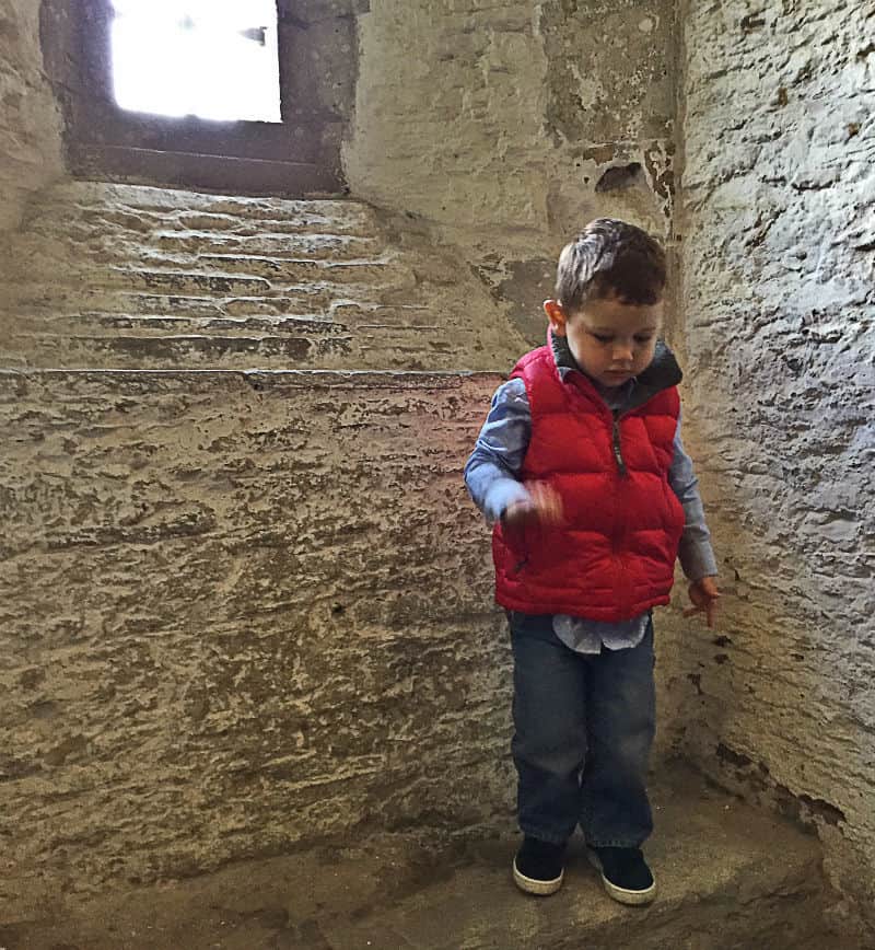 Toddler boy in Caerphilly castle in Southern Wales, UK