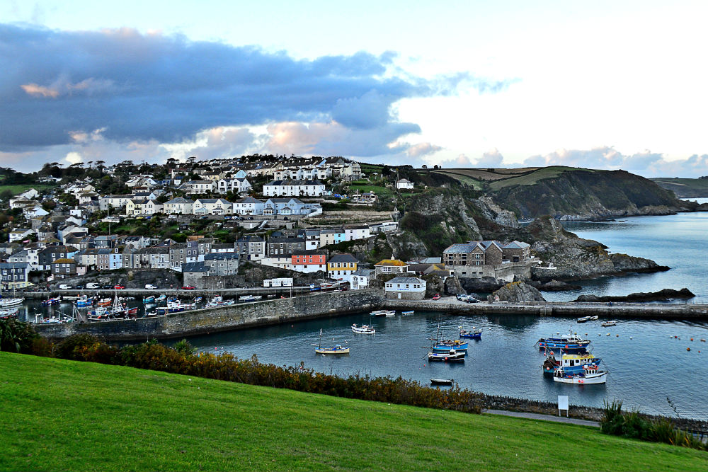 cornwall england with a village over a harbour at sunset