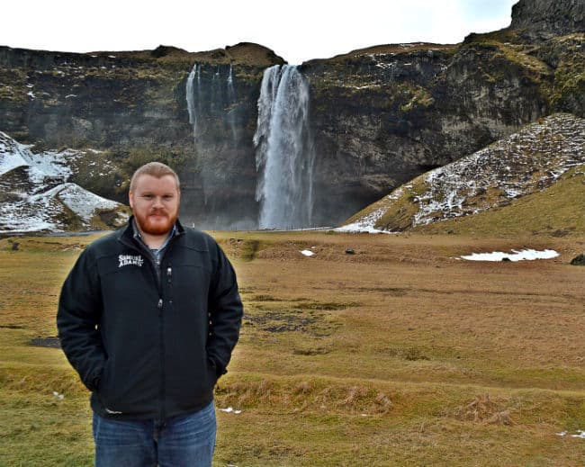 christian in front of Seljalandsfoss waterfall in iceland