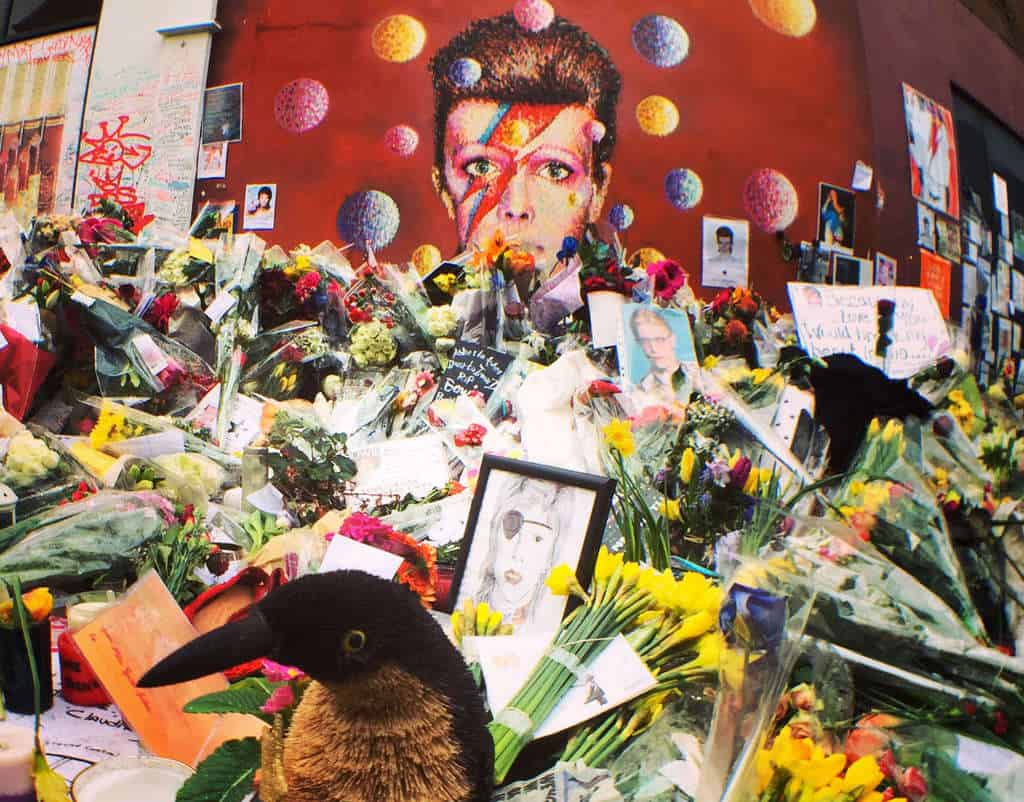 david bowie memorial mural in brixton, london with gifts and flowers by eileen cotter wright