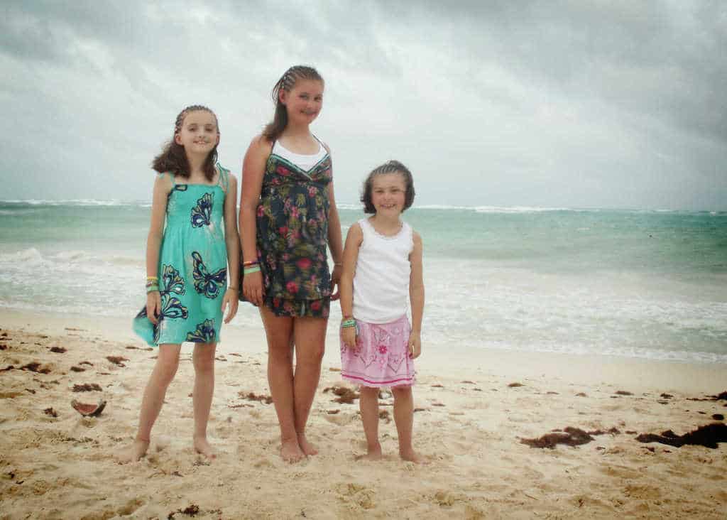 three girls in braids on a beach