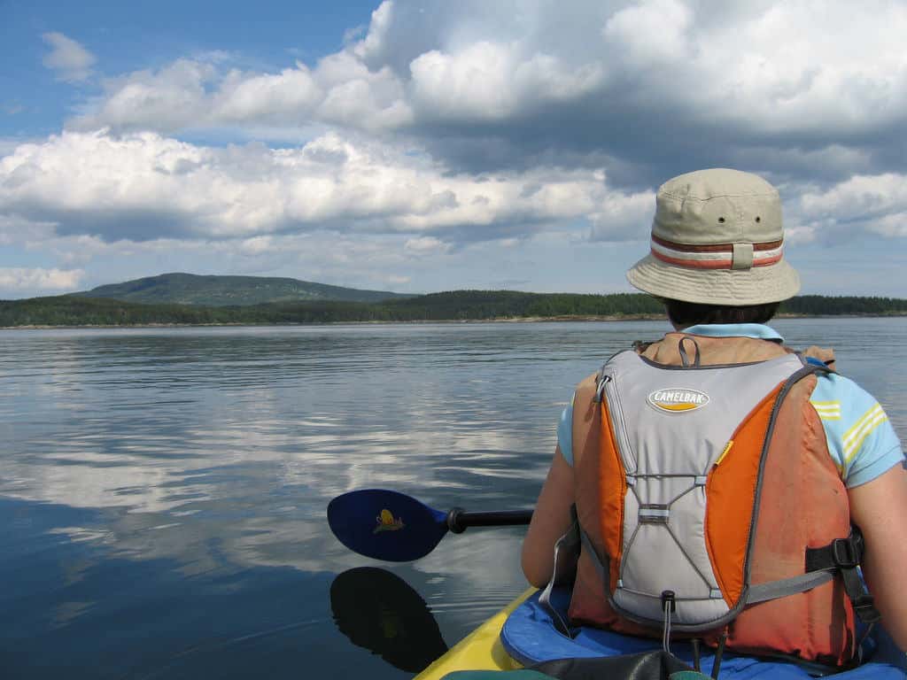 man in bucket hat in kayak in maine via flickr