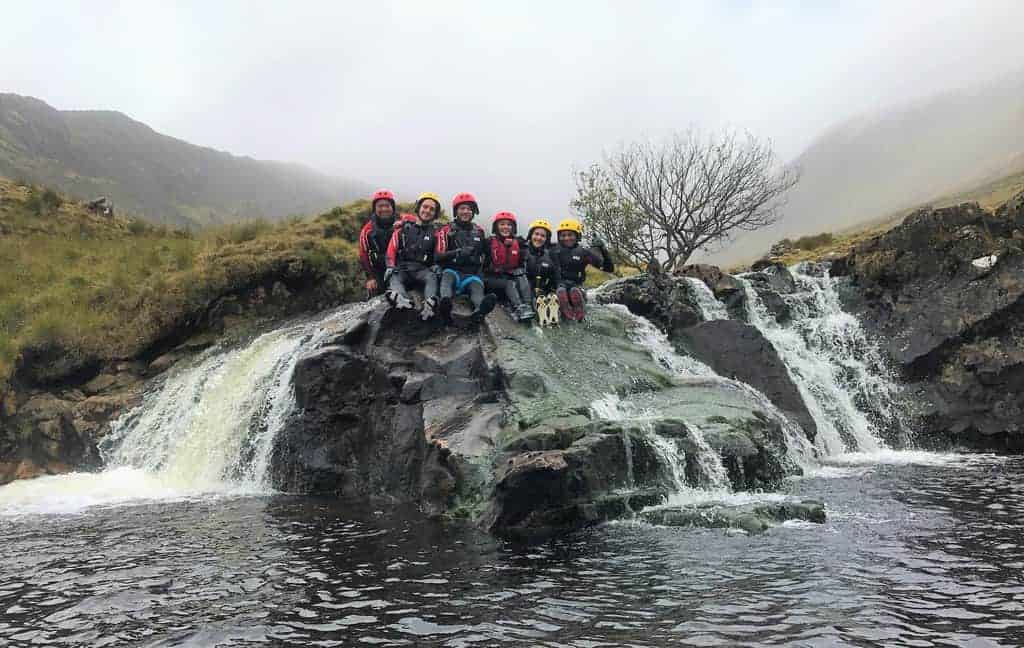 Dave with friends on a waterfall rock in Ireland