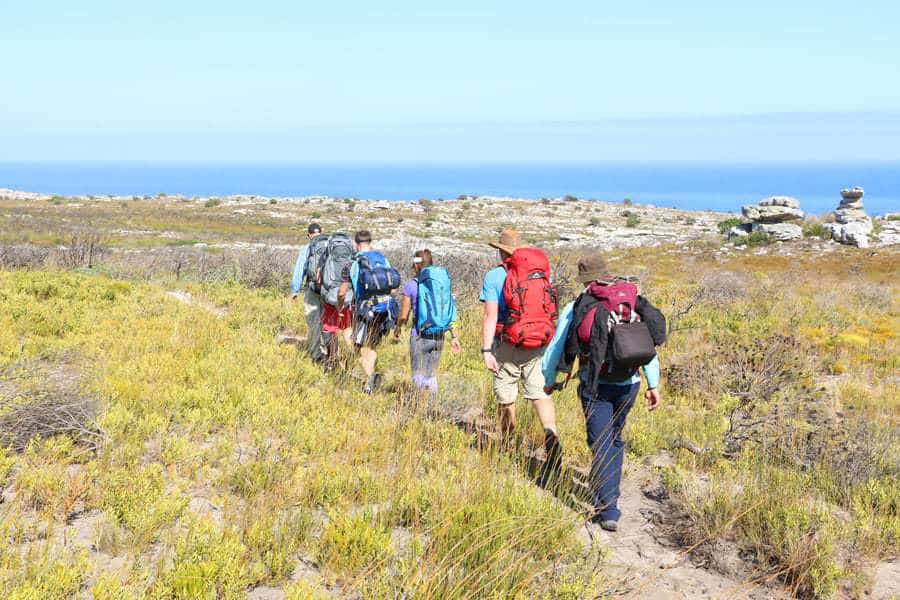 Group travel trekking through South Africa near ocean