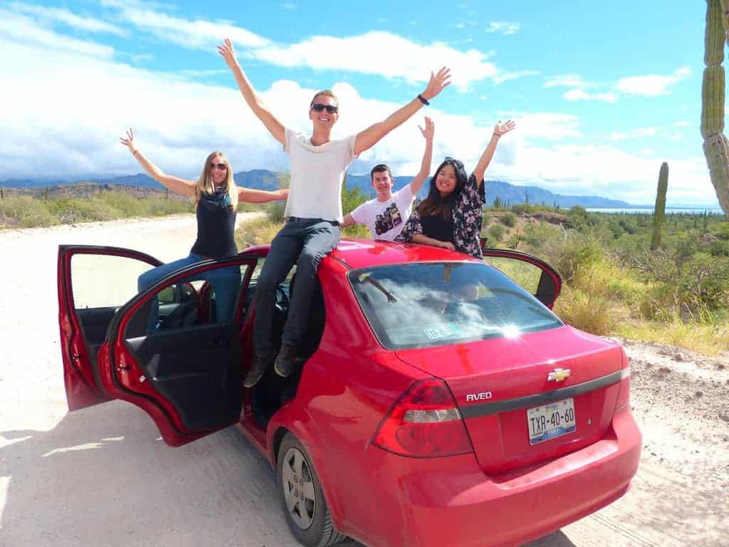 Patrick with group of friends and red car in Baja California