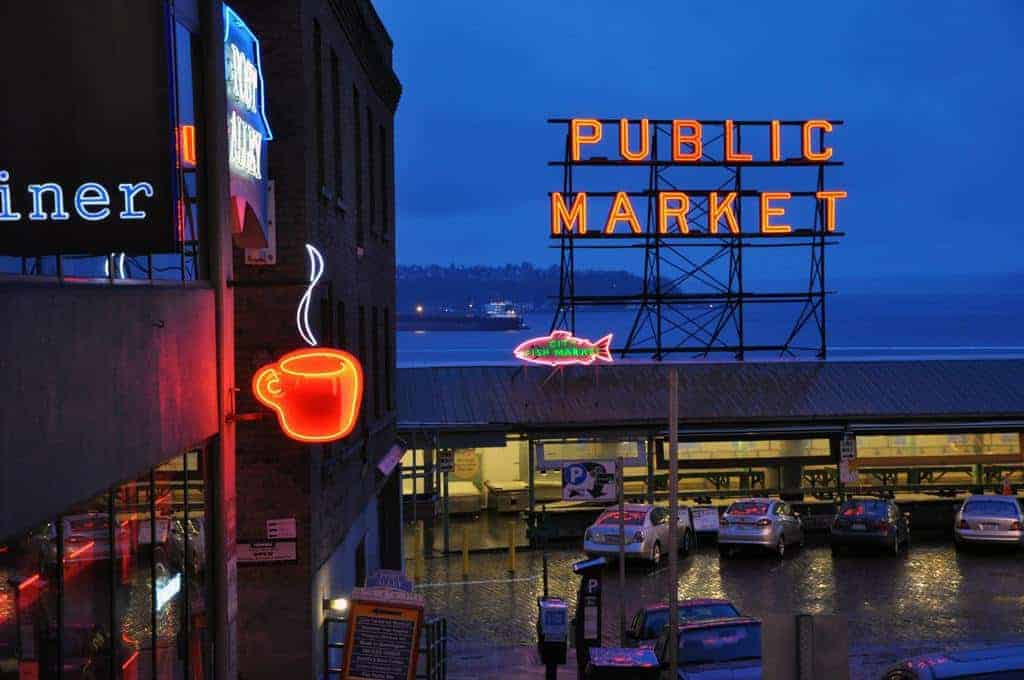 Downtown Seattle at night with public market sign