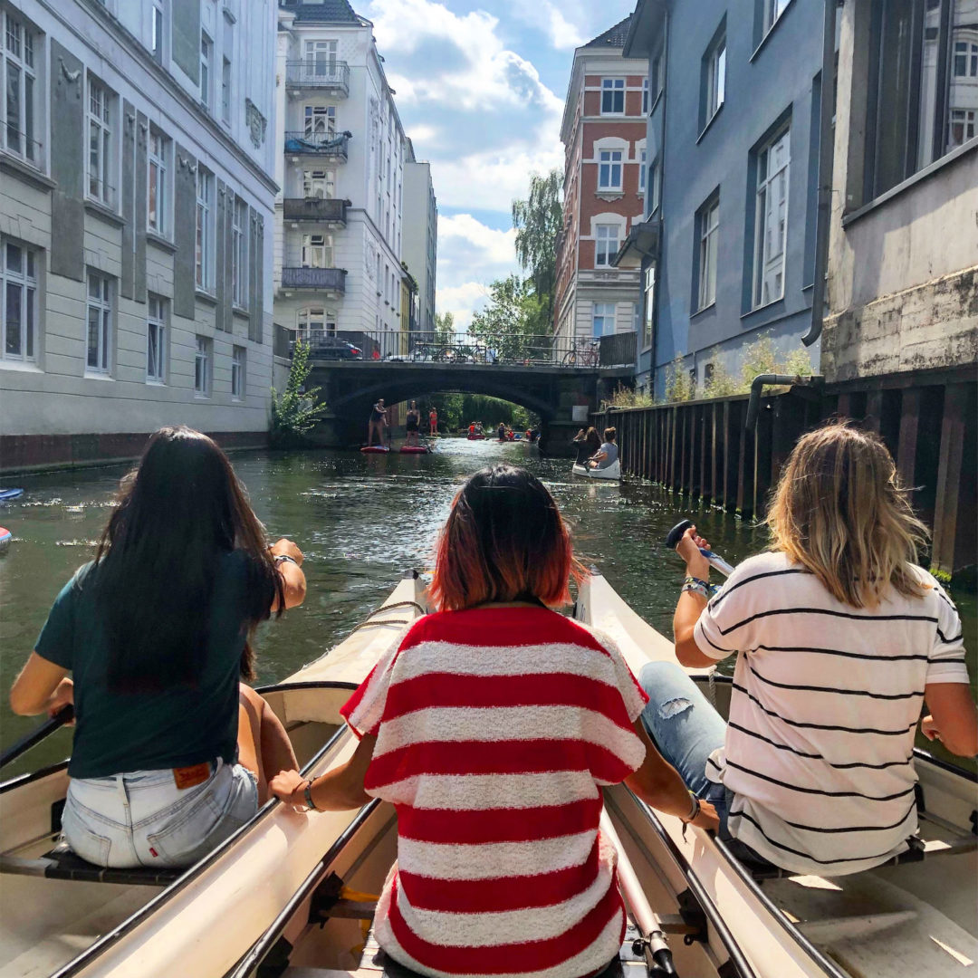 three canoes and women on the canal in hamburg germany