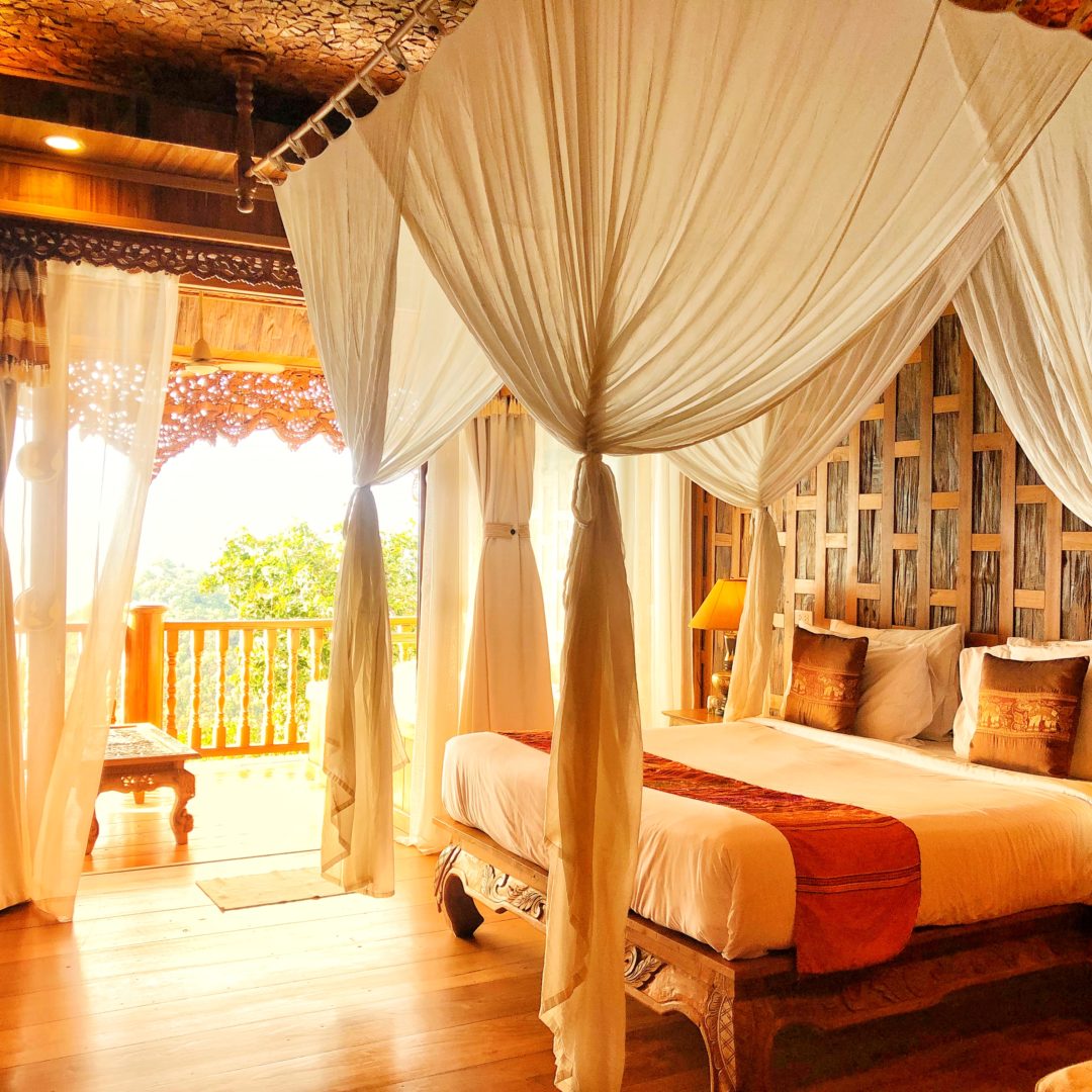 teakwood bed with canopy at Santhiya Koh Yao Yai Resort & Spa