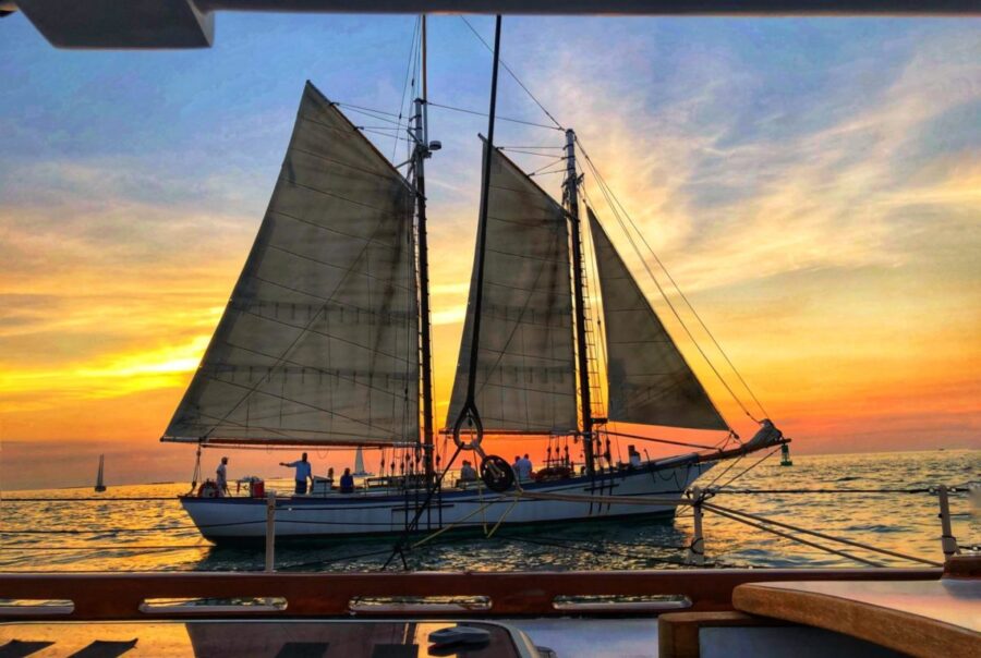 Sailboat siluette at sunset in key west florida with classic harbor line