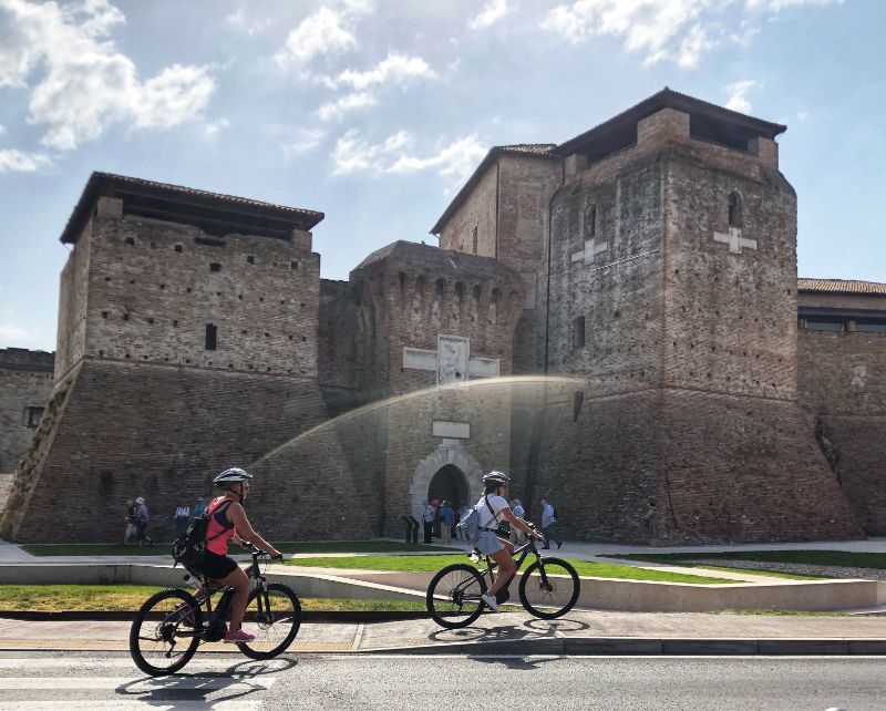 e-bikes in front of castle in rimini italy