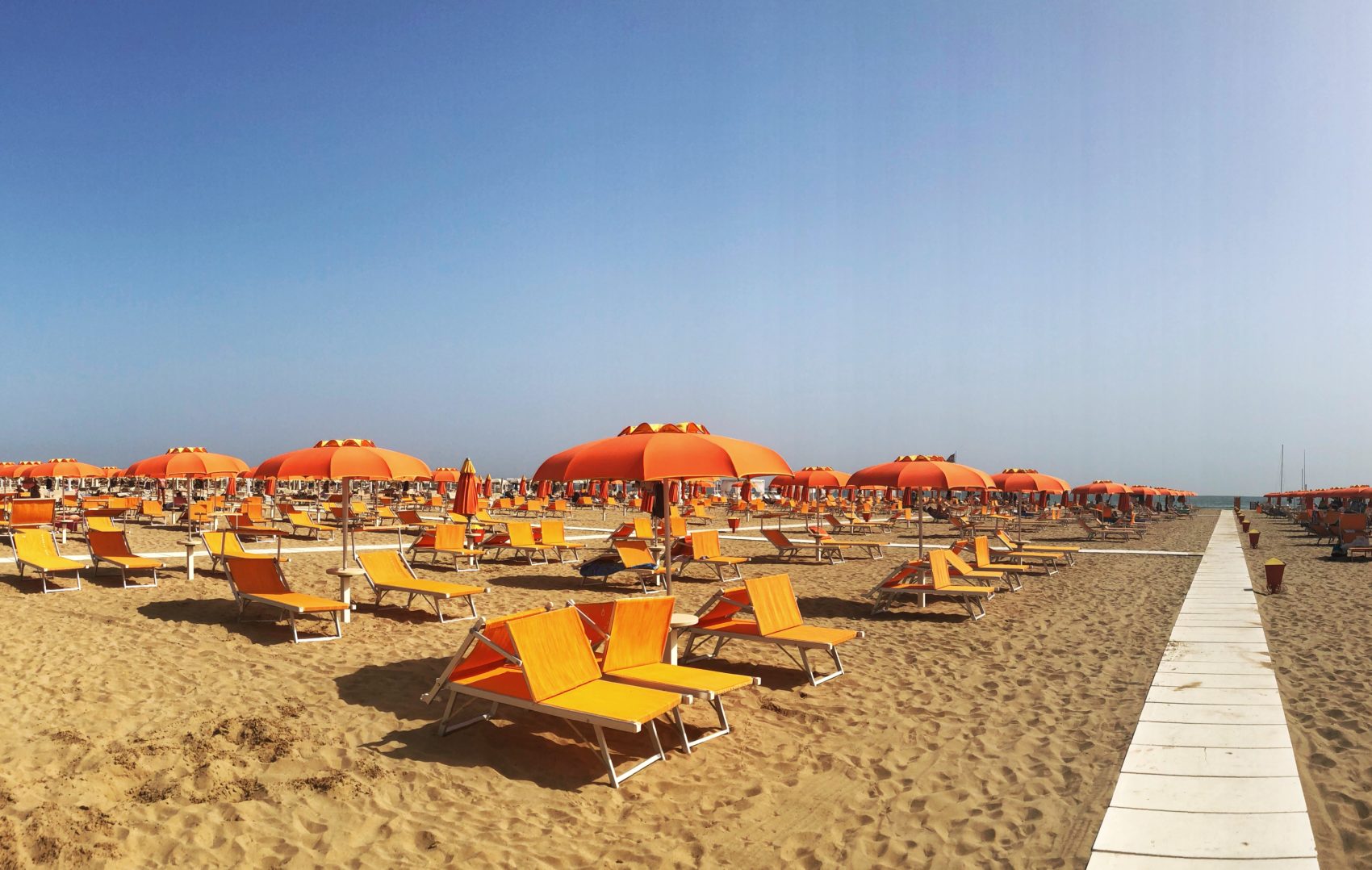 orange loungers on the beach in rimini italy
