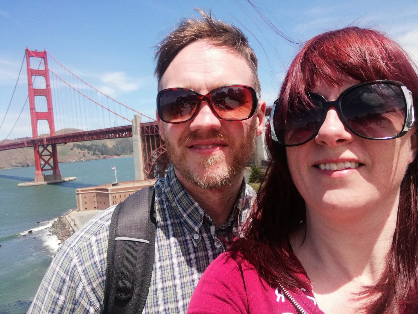 Oliver and wife in front of san Francisco bridge usa