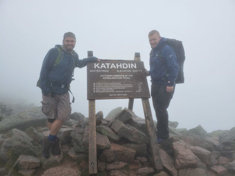 jake and christian on Katahdin Mountain summit in the fog in maine