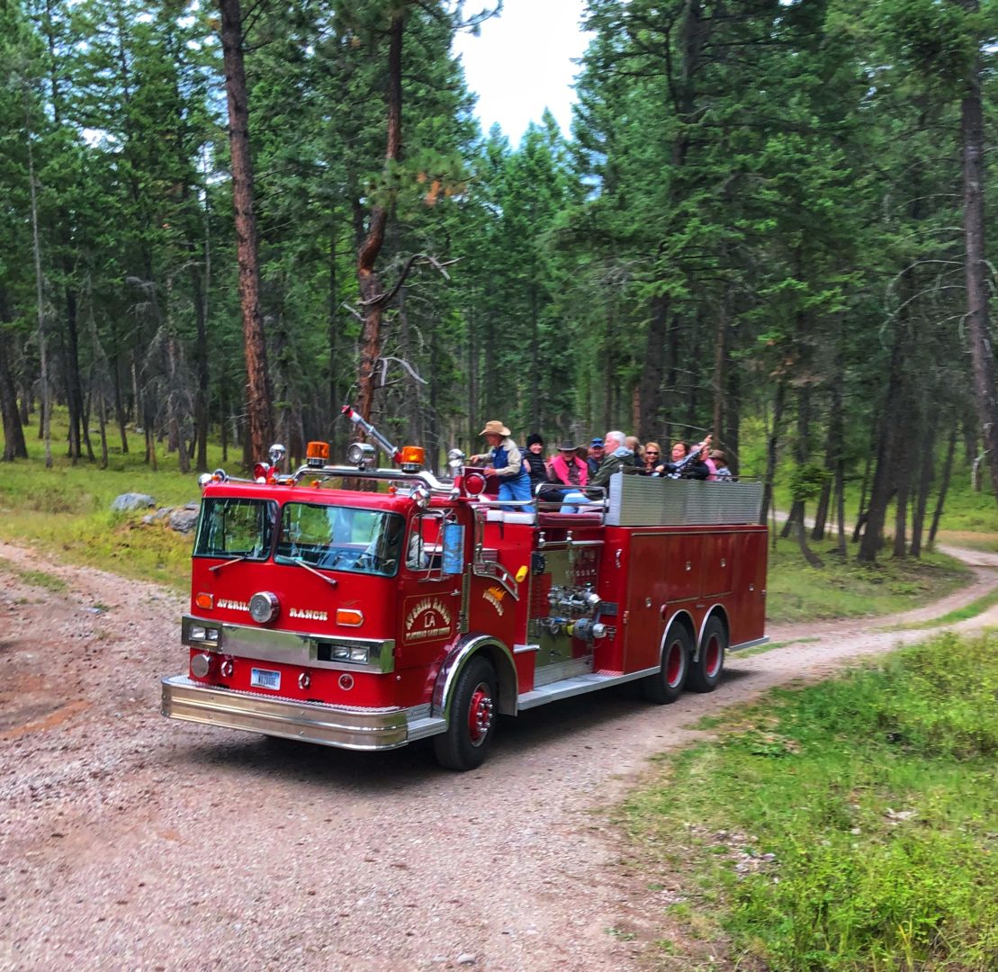 vintage fire truck ride through woods at flathead lake lodge