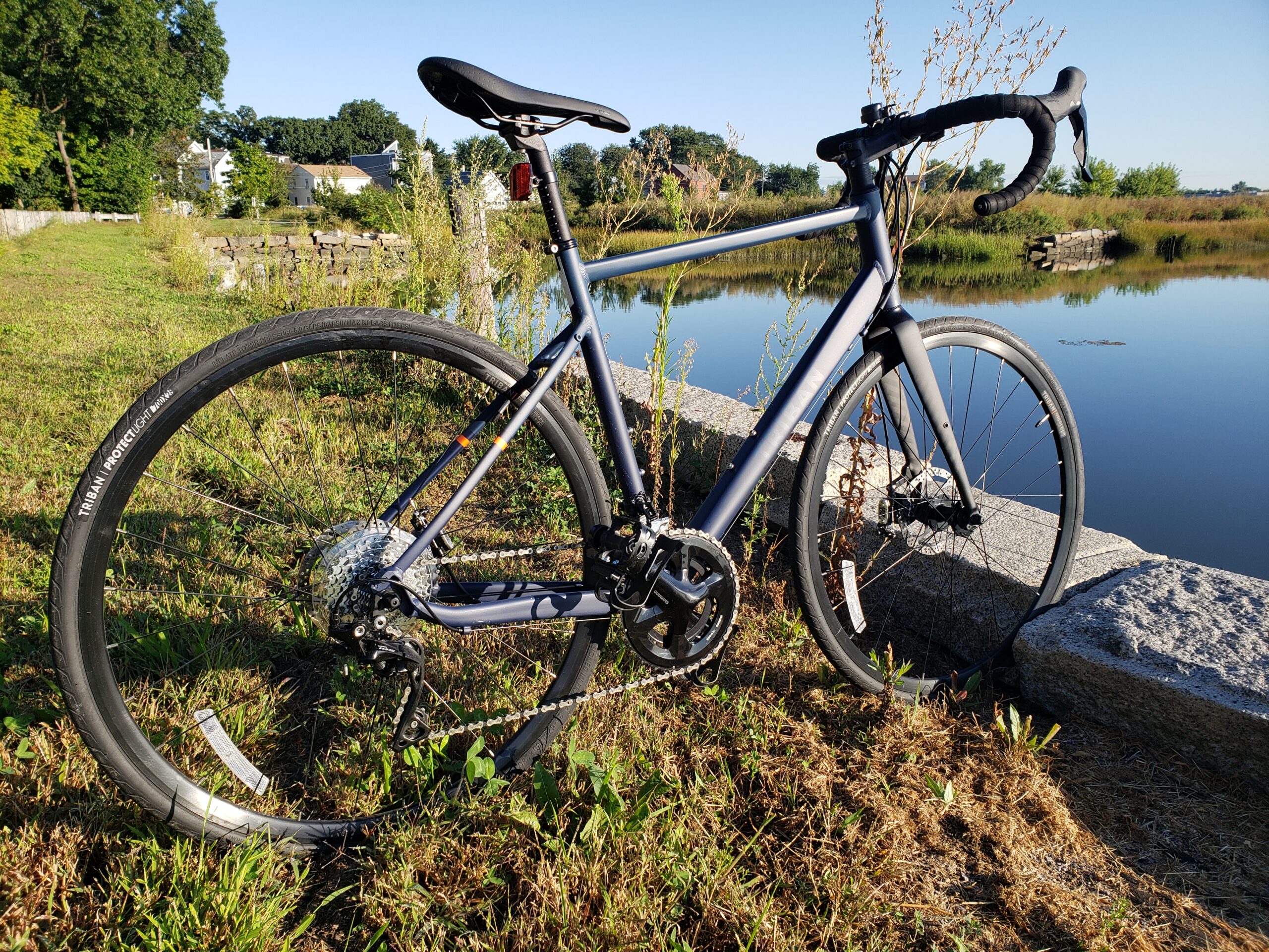 Decathalon's Triban bicycle on grass by some water