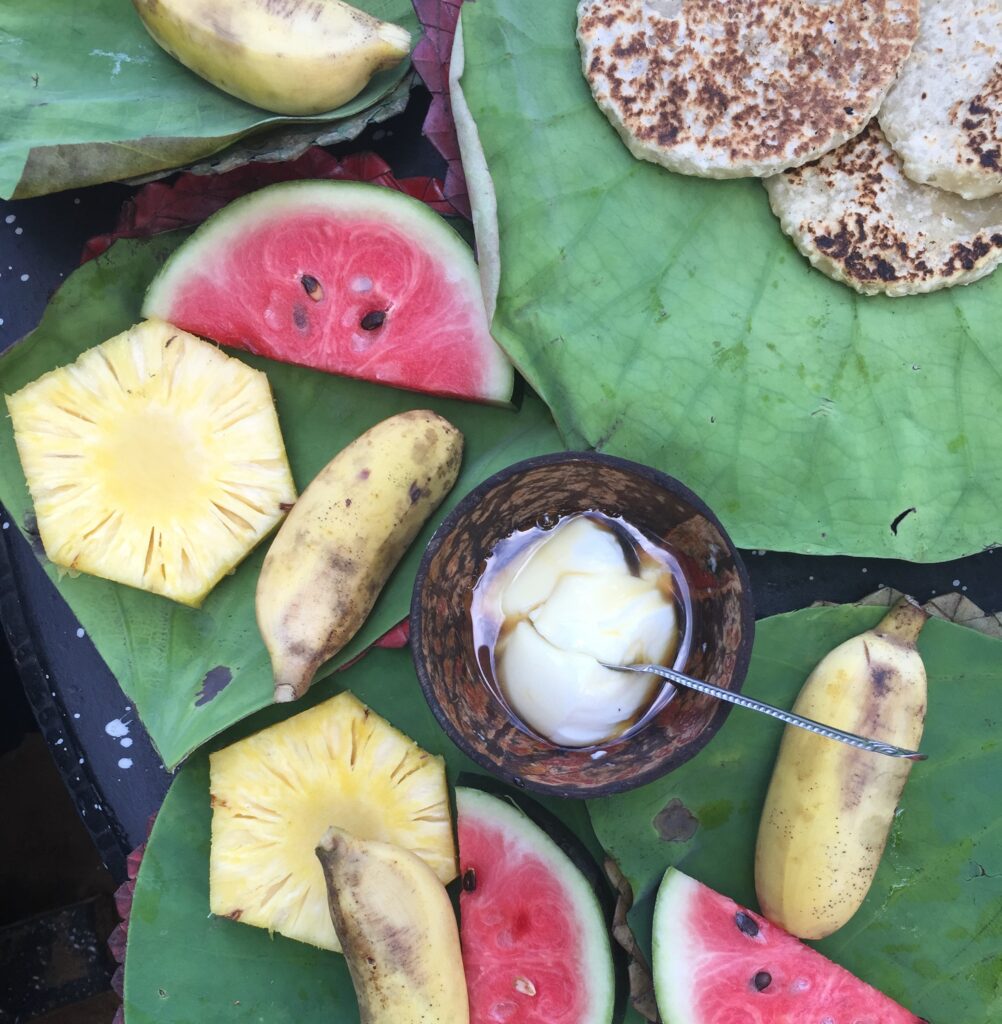 banana, pineapple and watermelon dessert on banana leaves