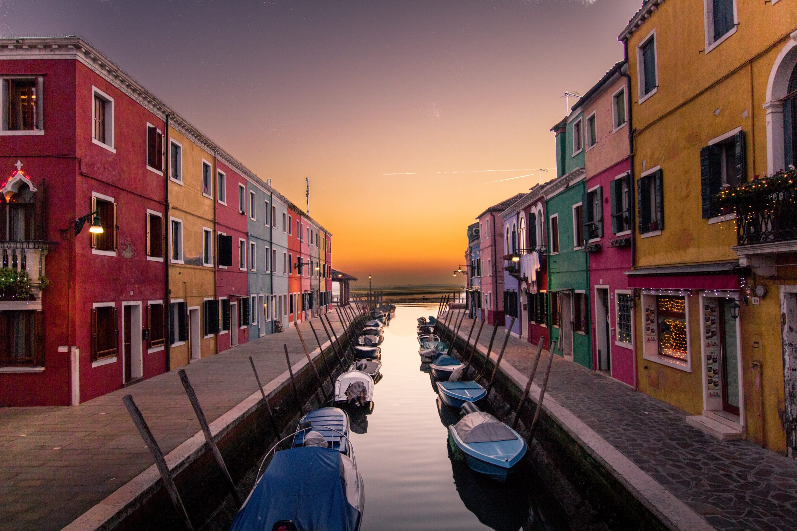 venice canals surrounded by colorful buildings at sunset