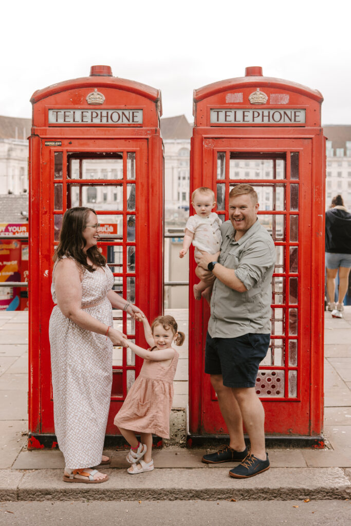 pure wander family in front of red london phone booth