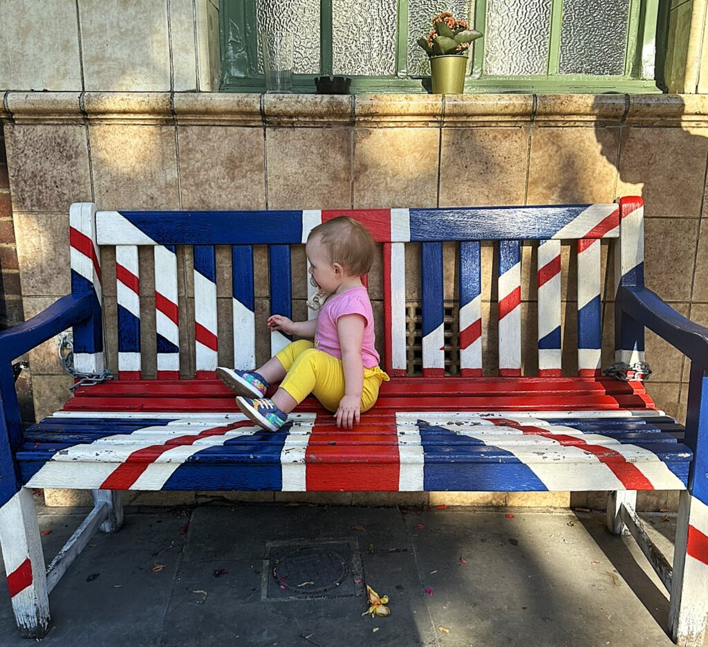 baby on bench painted with uk flag