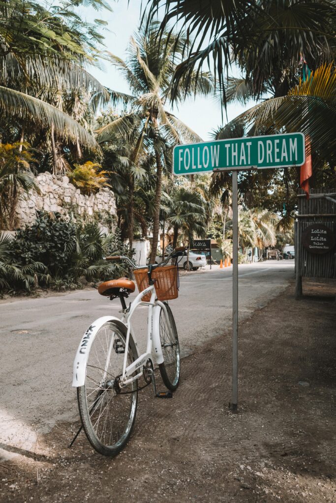 tulum bike and sign that says follow that dream